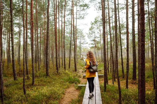 stock image Happy female tourist walk in the autumn forest. Nature. Trips. Active lifestyle.