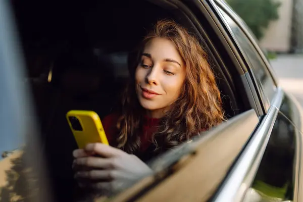 Young Woman Sits Back Seat Car Talks Phone Concept Business Imagens Royalty-Free