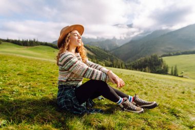 Bir dağ vadisinde seyahat eden genç ve çekici bir kız yolcunun portresi. Macera, seyahat konsepti.