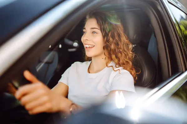 stock image Relaxed woman enjoys drive while sitting in a car. Car travel concept. Lifestyle.