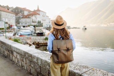 Turist kadının gözlem güvertesindeki arka görüntüsü şehrin ve körfezin renkli manzarasına hayran. Seyahat, tatil, aktif yaşam tarzı.