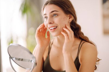 Sivilceli makyajsız genç bir kadının portresi. Deri problemleri, ilk taklit kırışıklıklar ya da sivilceler, siyah noktalardan rahatsız olmuş..