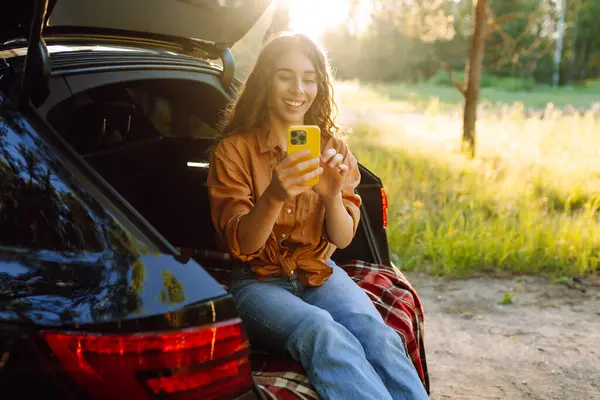 stock image Happy woman taking selfie on her road trip. Pretty woman exploring the local nature. Travel by car.