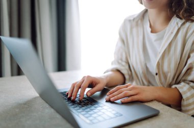 Kapatın. Öğleden sonra sıcak, kapalı bir mekanda çay içerken dizüstü bilgisayarda yazan kişi. İş, serbest meslek, alışveriş, eğitim. Çevrimiçi.