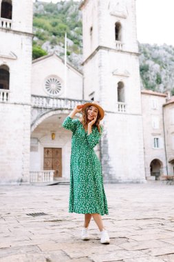 Şehrin sokaklarında yürüyen güzel elbiseli mutlu bir bayan turist. Moda tarzı. Tatil ve seyahat kavramı. 