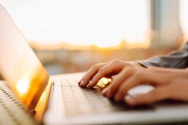 Dişi eller dışarıda dizüstü bilgisayarda çalışıyor. İş, eğitim, alışveriş. Çevrimiçi