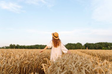 Güzel bir kadın altın buğday tarlasında gün batımını seyrediyor. Şapkalı genç bir turist özgürlüğünü hissediyor, tarımda yürüyor. Güzellik, özgürlük kavramı. Yaşam biçimi.