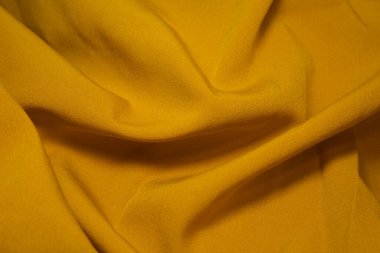 Sarı kumaş arka plan. Sarı kumaş arka plan dokusunu dalgalandırır. Sarı kumaş kumaş kumaş kumaş..