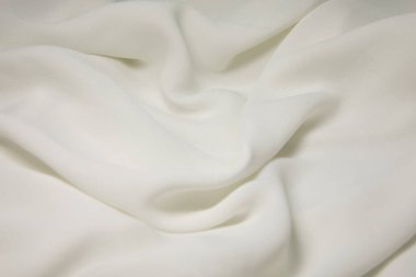 White fabric background. White cloth waves background texture. White fabric cloth textile material.