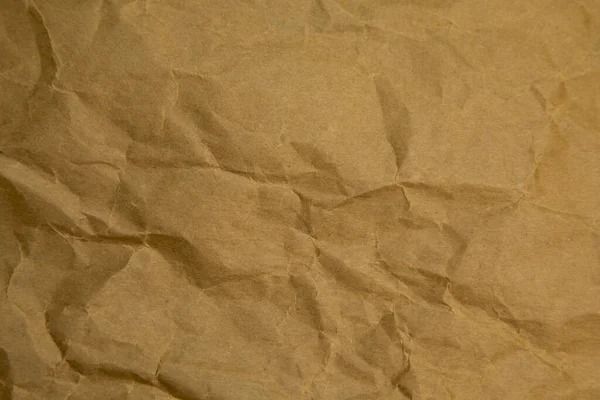 Brown wrinkle paper background texture. Brown template. Brown paper background.
