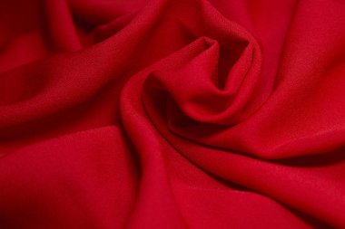 Kırmızı kumaş arka plan. Kırmızı bez dalgaları arka plan dokusu. Kırmızı kumaş kumaş kumaş kumaş..