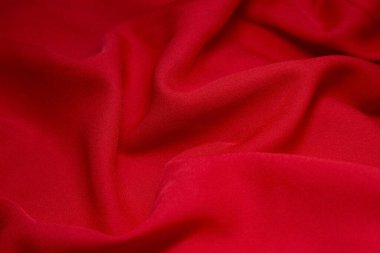 Kırmızı kumaş arka plan. Kırmızı bez dalgaları arka plan dokusu. Kırmızı kumaş kumaş kumaş kumaş..
