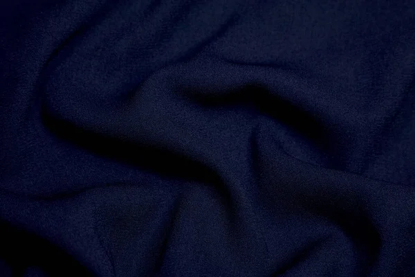 Black fabric background. Black cloth waves background texture. Black fabric cloth textile material.