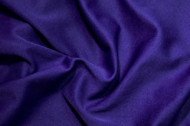 Blue fabric background. Blue cloth waves background texture. Blue fabric cloth textile material.