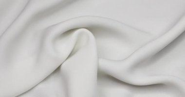 White fabric background. White cloth waves background texture. White fabric cloth textile material.
