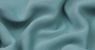 Teal kumaş arka planı. Teal bezi arka plan dokusunu dalgalandırır. Teal kumaş kumaş tekstil malzemesi.