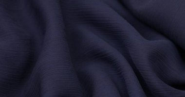 Blue fabric background. Blue cloth waves background texture. Blue fabric cloth textile material.