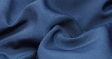 Blue fabric background. Blue cloth waves background texture. Blue fabric cloth textile material.