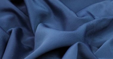 Blue fabric background. Blue cloth waves background texture. Blue fabric cloth textile material.