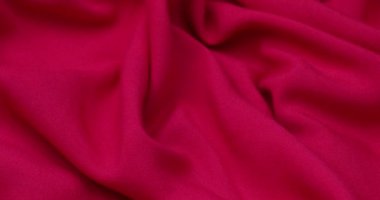 Pink fabric background. Pink cloth waves background texture. Pink fabric cloth textile material.