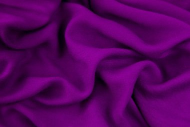 Mor kumaş arka plan. Mor kumaş dalgaları arka plan dokusu. Mor kumaş kumaş kumaş kumaş..