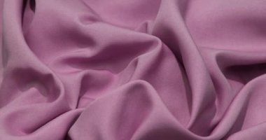 Pink fabric background. Pink cloth waves background texture. Pink fabric cloth textile material.