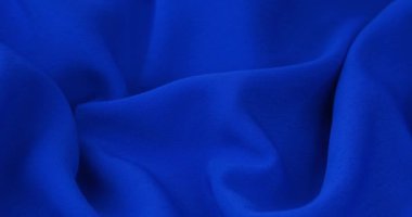 Blue fabric background. Blue cloth waves background texture. Blue fabric cloth textile material.