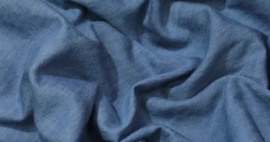 Mavi kot kumaş arka plan. Mavi kot kumaş arka plan dokusunu dalgalandırıyor. Mavi kot kumaş kumaş kumaş kumaş..