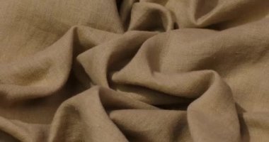 Kahverengi kumaş arka plan. Kahverengi bez dalgaları arka plan dokusu. Kahverengi kumaş kumaş tekstil malzemesi.
