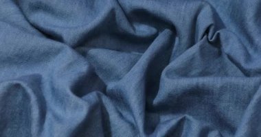 Mavi kot kumaş arka plan. Mavi kot kumaş arka plan dokusunu dalgalandırıyor. Mavi kot kumaş kumaş kumaş kumaş..