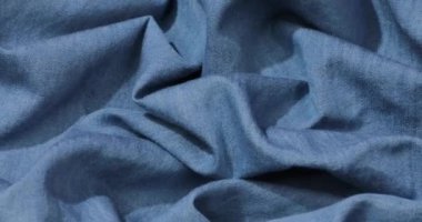 Mavi kot kumaş arka plan. Mavi kot kumaş arka plan dokusunu dalgalandırıyor. Mavi kot kumaş kumaş kumaş kumaş..