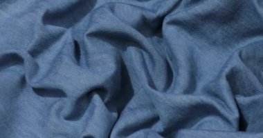 Mavi kot kumaş arka plan. Mavi kot kumaş arka plan dokusunu dalgalandırıyor. Mavi kot kumaş kumaş kumaş kumaş..