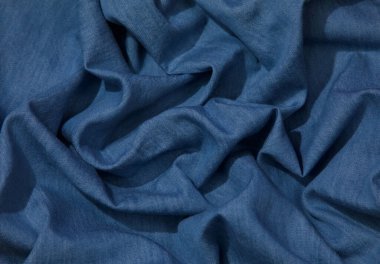 Mavi kot kumaş arka plan. Mavi kot kumaş arka plan dokusunu dalgalandırıyor. Mavi kot kumaş kumaş kumaş kumaş..