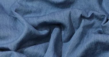Mavi kot kumaş arka plan. Mavi kot kumaş arka plan dokusunu dalgalandırıyor. Mavi kot kumaş kumaş kumaş kumaş..