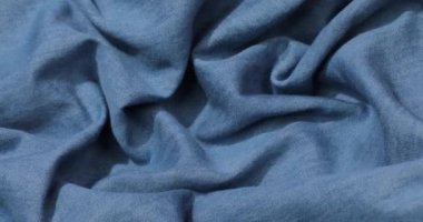 Mavi kot kumaş arka plan. Mavi kot kumaş arka plan dokusunu dalgalandırıyor. Mavi kot kumaş kumaş kumaş kumaş..