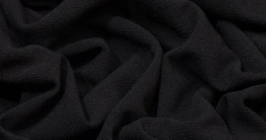Black fabric background. Black cloth waves background texture. Black fabric cloth textile material.