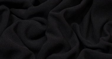 Black fabric background. Black cloth waves background texture. Black fabric cloth textile material.