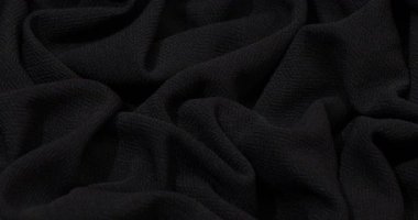 Black fabric background. Black cloth waves background texture. Black fabric cloth textile material.