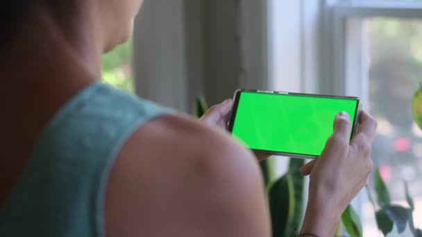 Женщина Смартфоном Зеленым Экраном Хрома Ключ Дома Глядя Экран Прикосновения — стоковое видео