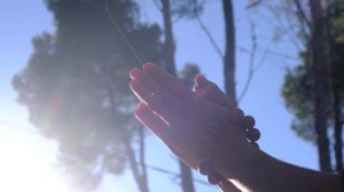  Taoist Budist tütsülü kadın eli, doğal çevre kavramında güneş ışınları ile tespih, huzur, sükunet, farkındalık yoga, meditasyon.