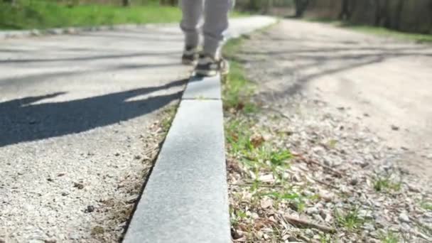 Boy Walks Curb Keeps His Balance — Stock Video