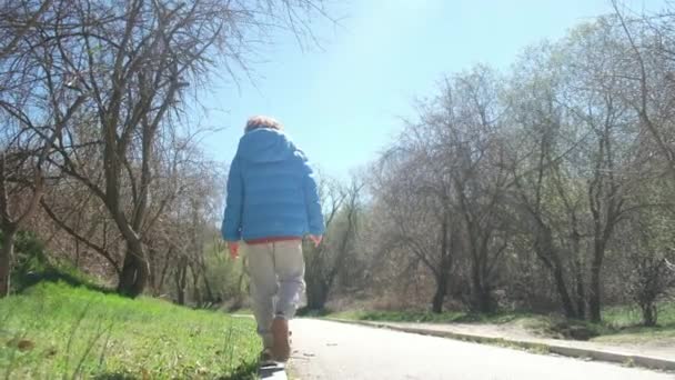 Αγόρι Περπατάει Στο Πεζοδρόμιο Και Κρατάει Την Ισορροπία Του — Αρχείο Βίντεο