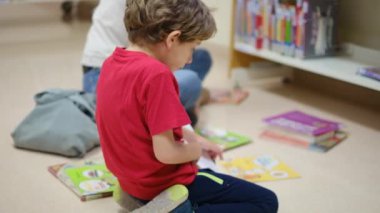 Anne ve Çocuklar Kitapçıda. Çocuklarının kitap seçmesine yardım eden bir anne.