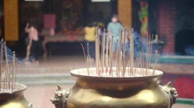 Tapınakta tütsü çubukları yakmak. Budist ve Hindu tapınaklarında geleneksel adak