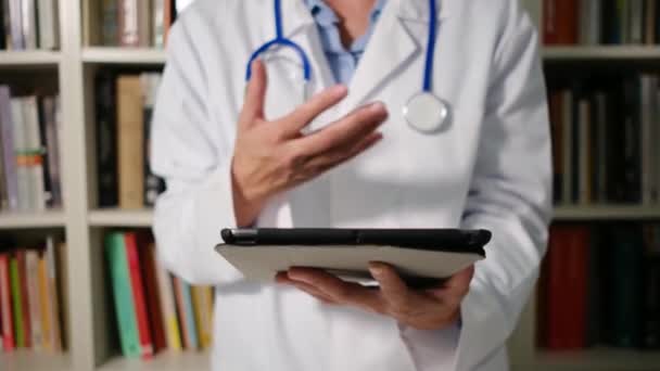 閉じた女性医師は 病院で白いコートを着てタブレットを使用しています — ストック動画