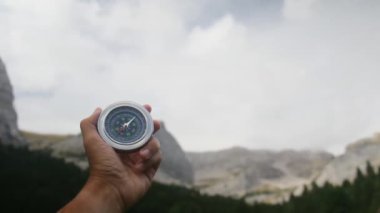 Dağlarda pusula tutan bir adam 