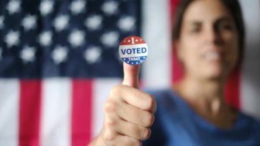 Bugün birlikte oy verdiğim kadın ABD bayrağının arka planında. 