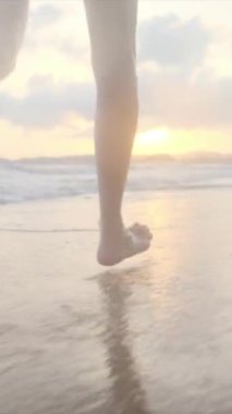  Yaz tatilinde ya da tatilde deniz ya da okyanus kenarında koşan kadın bacakları. Sahilde, doğada ve özgürlükte bir kadın tek başına akıntıda, gelgitte ya da dalgalarda yürür.