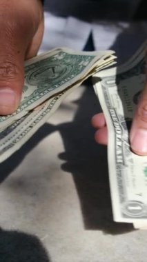 close up man counting dollars bills