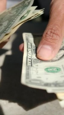 close up man counting dollars bills
